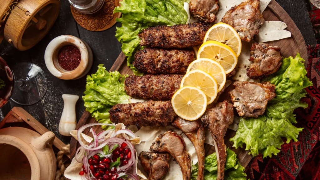 Best Persian Kebab in Sydney: A generous Persian family platter featuring grilled Koobideh kebabs and lamb cuts on a wooden board, garnished with lemon slices.