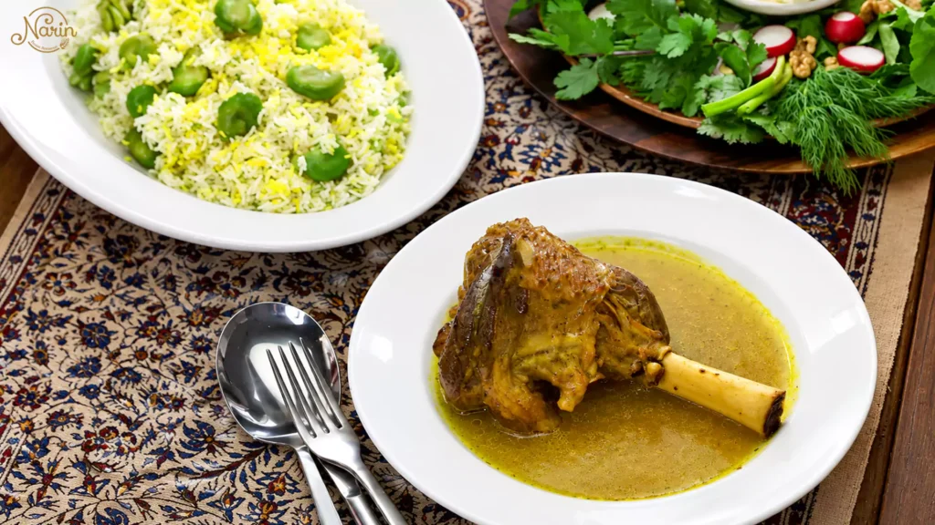 Authentic Persian Baghali Polo ba Mahiche at Narin Persian Restaurant in Sydney, featuring a tender slow-cooked lamb shank in a rich saffron broth, served alongside fluffy dill and fava bean rice and a fresh herb platter (Sabzi Khordan) on a traditional patterned tablecloth.