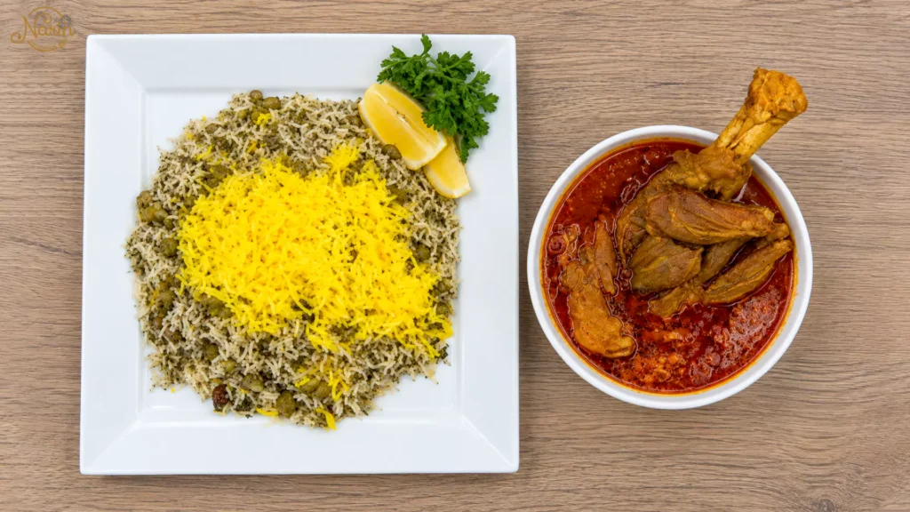 Traditional Persian Baghali Polo with saffron rice and tender lamb shank, served with lemon and fresh herbs