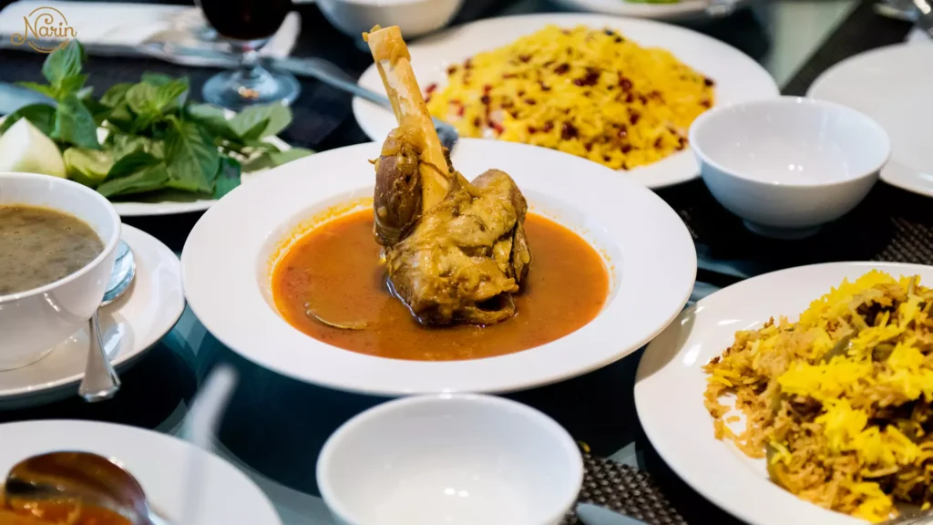 A traditional Persian lamb shank (Mahiche) served in a savory broth with saffron rice at Narin, the best Persian restaurant in Northmead.   