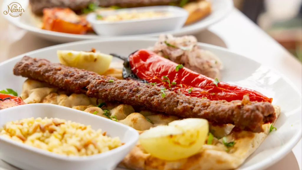 A delicious plate of gas-grilled Koobideh kebab served on flatbread, showcasing exactly what to order at a Persian restaurant like Narin.   